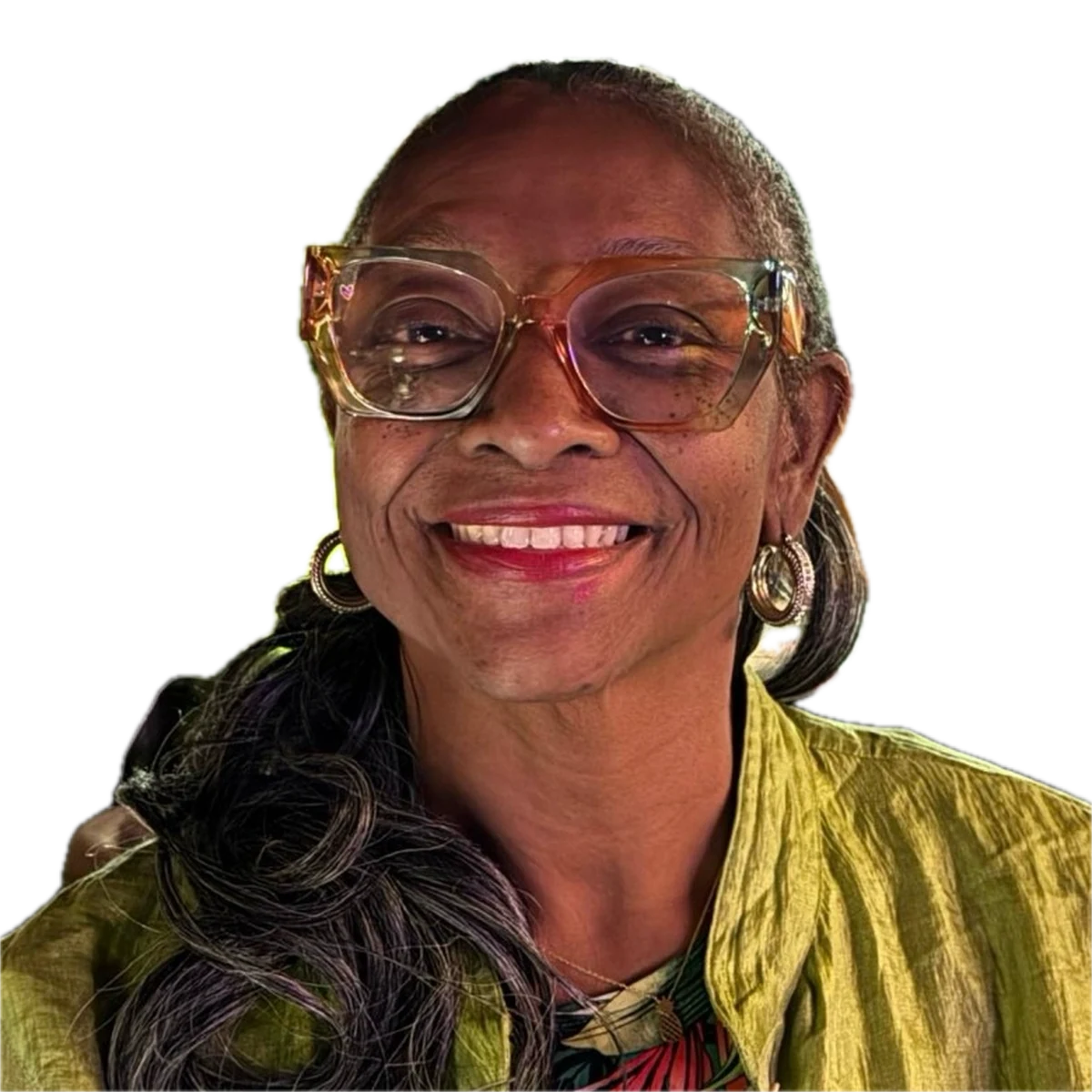 Connie smiling, seated in a plant-filled room