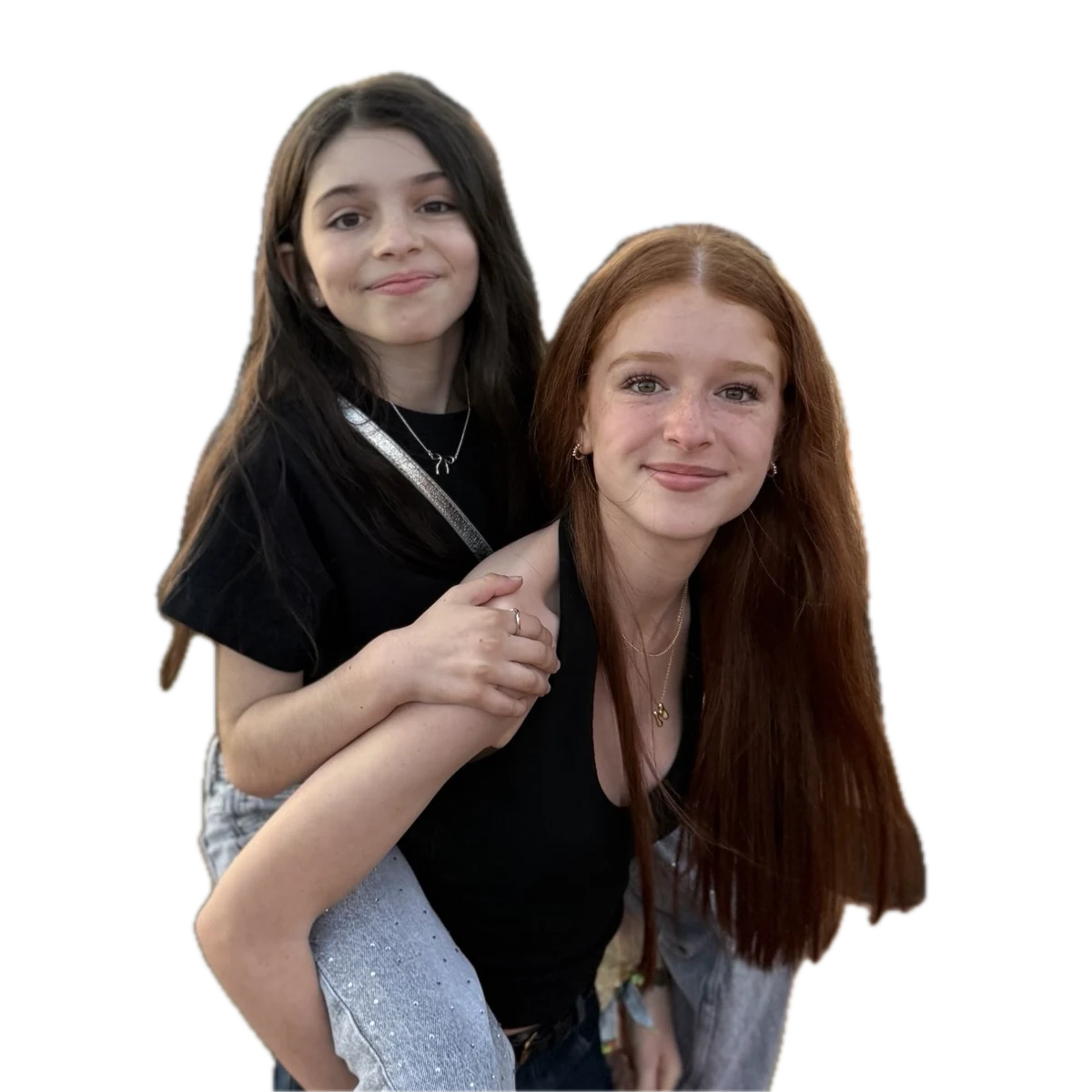Two girls smiling together at an outdoor event